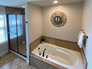 2110 Escalade Rd, Bloomington, IL 61705 - full bath featuring a bath, a shower stall, recessed lighting, and baseboards