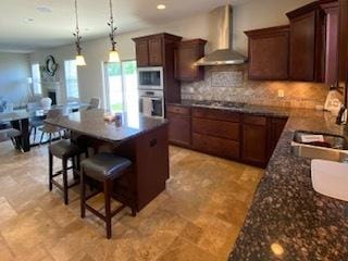 2110 Escalade Rd, Bloomington, IL 61705 - kitchen featuring a sink, wall chimney range hood, dark countertops, and stainless steel appliances