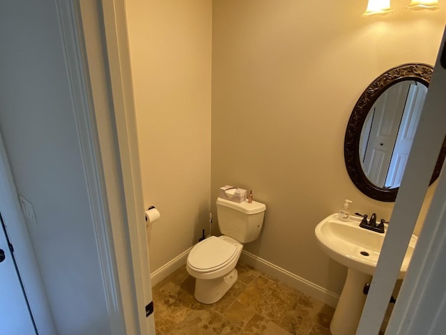 2110 Escalade Rd, Bloomington, IL 61705 - bathroom with a sink, toilet, and baseboards