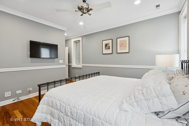 bedroom with wood finished floors, recessed lighting, baseboards, ornamental molding, and a ceiling fan