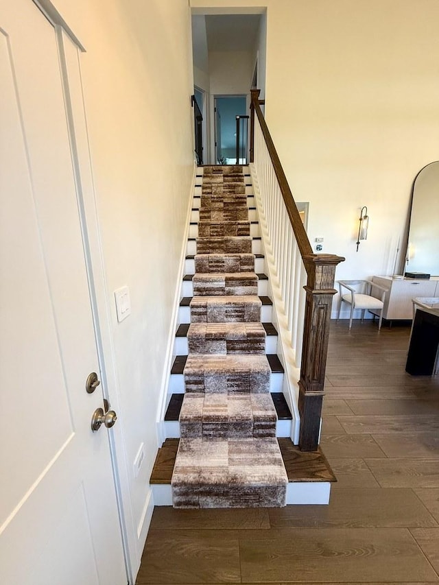 stairway with baseboards and wood finished floors