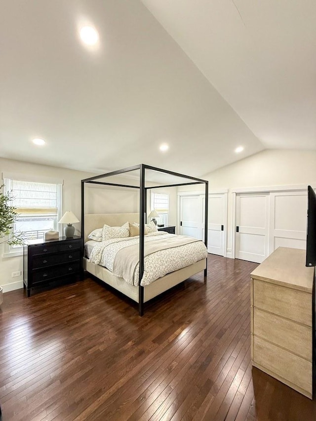 bedroom with dark wood-type flooring, recessed lighting, and vaulted ceiling