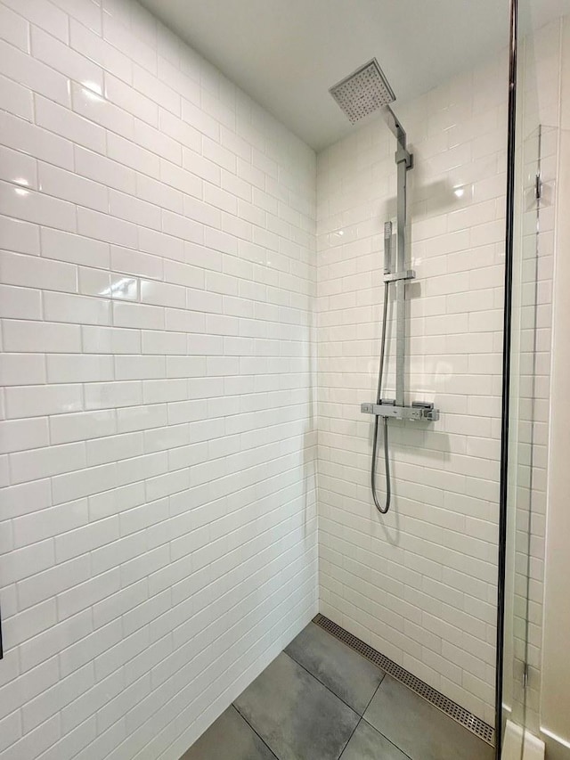 bathroom featuring tile patterned floors and tiled shower