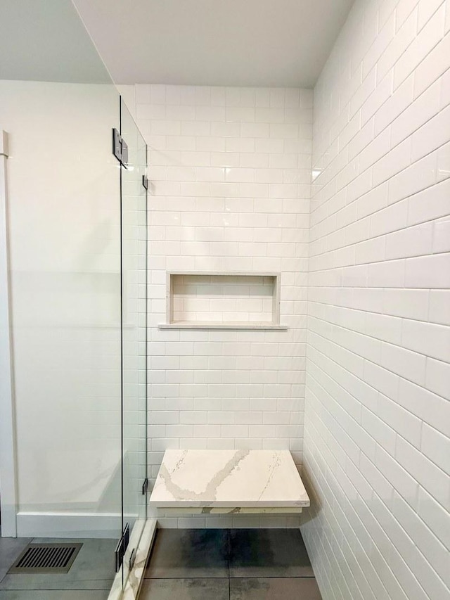 bathroom with visible vents and a stall shower