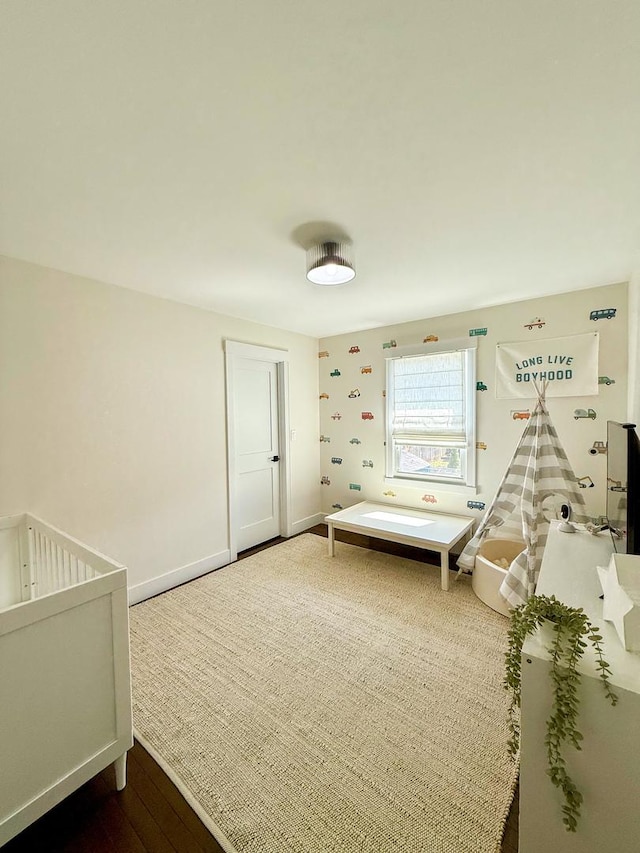 bedroom with baseboards and wood finished floors