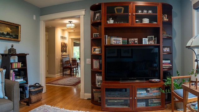 living room featuring light wood-type flooring and baseboards