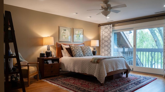 bedroom with access to outside and light wood-style floors