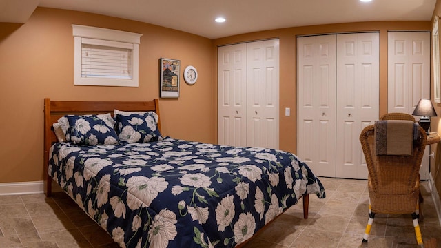 bedroom with recessed lighting, multiple closets, and baseboards