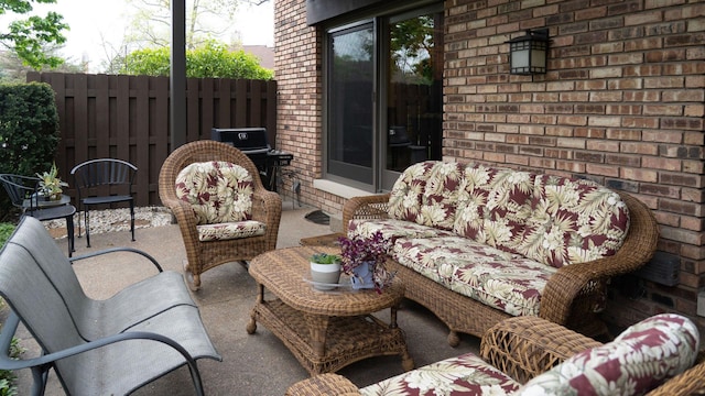 view of patio featuring outdoor lounge area and fence
