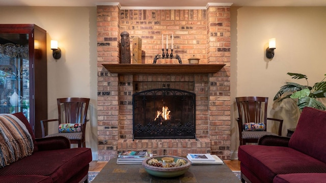 living area featuring a brick fireplace and wood finished floors