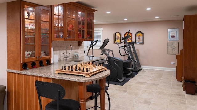 indoor bar with recessed lighting, tasteful backsplash, baseboards, and light tile patterned floors