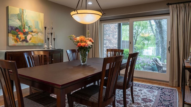 dining area with wood finished floors and recessed lighting