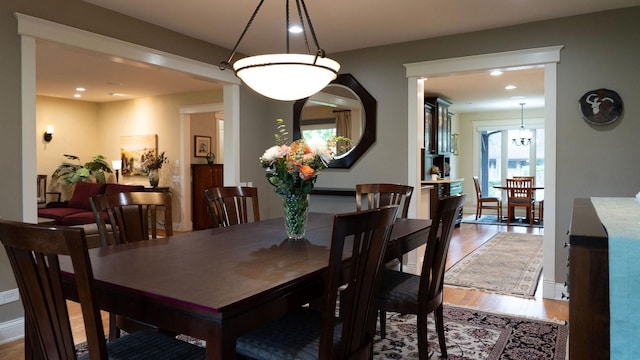 dining area featuring wood finished floors and recessed lighting