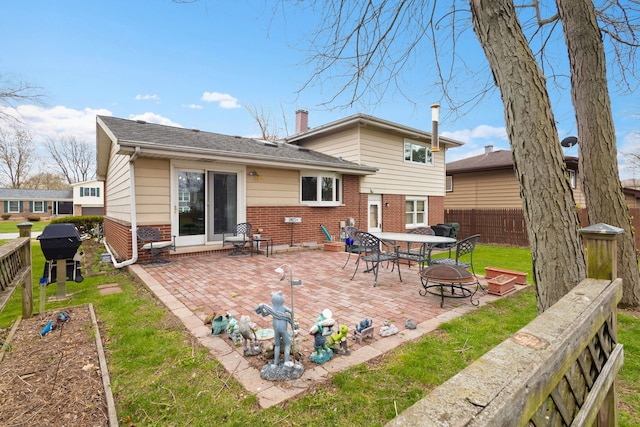 18524 Center Ave, Homewood, IL 60430 - rear view of house featuring a fenced backyard, a chimney, brick siding, and a patio area