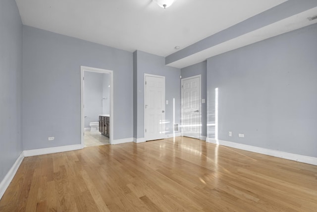 4532 S Indiana Ave Unit 2N, Chicago, IL 60653 - unfurnished bedroom with light wood-style floors, baseboards, and ensuite bath