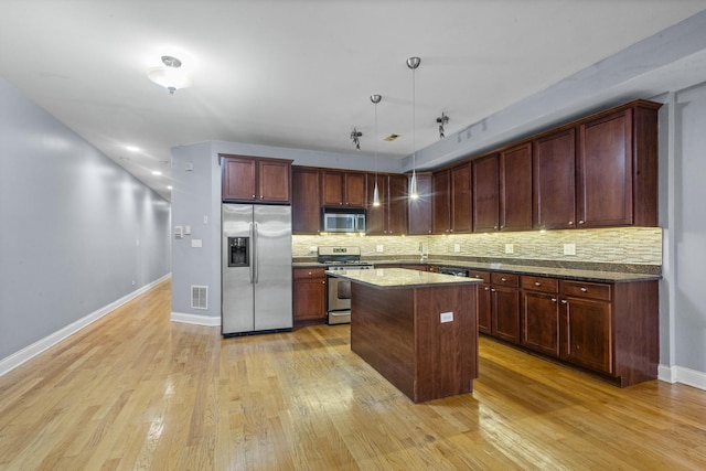 4532 S Indiana Ave Unit 2N, Chicago, IL 60653 - kitchen with appliances with stainless steel finishes, light wood finished floors, decorative backsplash, and baseboards