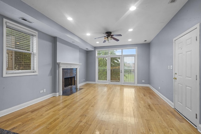 4532 S Indiana Ave Unit 2N, Chicago, IL 60653 - unfurnished living room featuring a ceiling fan, light wood-style floors, a tiled fireplace, baseboards, and recessed lighting