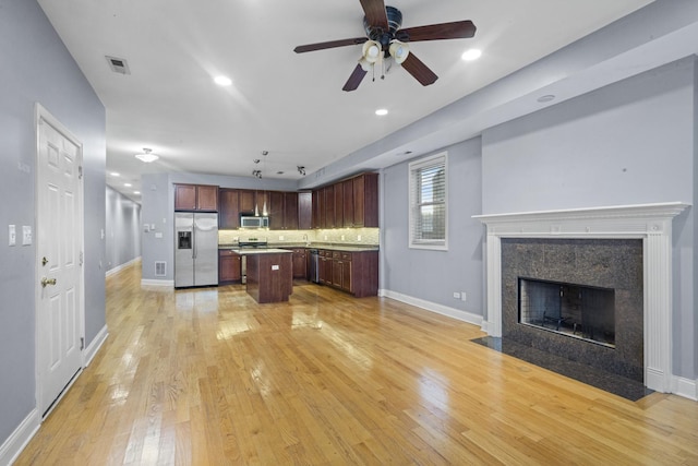 4532 S Indiana Ave Unit 2N, Chicago, IL 60653 - kitchen with appliances with stainless steel finishes, open floor plan, a center island, a ceiling fan, and light wood finished floors