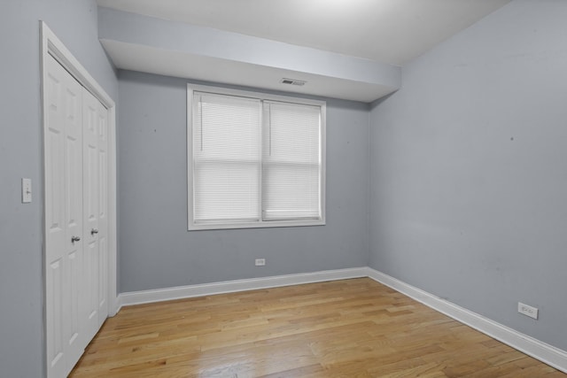 4532 S Indiana Ave Unit 2N, Chicago, IL 60653 - unfurnished bedroom featuring light wood-style floors, a closet, and baseboards