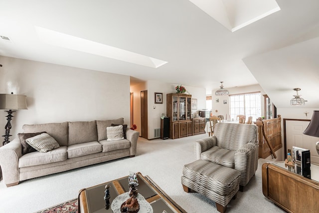 living area with light colored carpet and a skylight