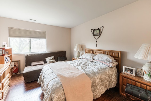 bedroom featuring hardwood / wood-style flooring and visible vents