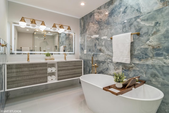 bathroom with a freestanding tub, recessed lighting, a sink, tile walls, and double vanity