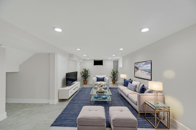living area featuring baseboards and recessed lighting
