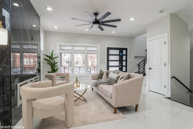 living area featuring ceiling fan, recessed lighting, and stairway