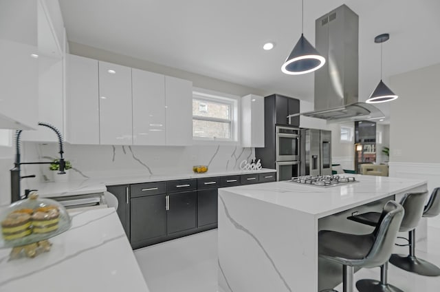 kitchen with island range hood, modern cabinets, white cabinets, and stainless steel appliances