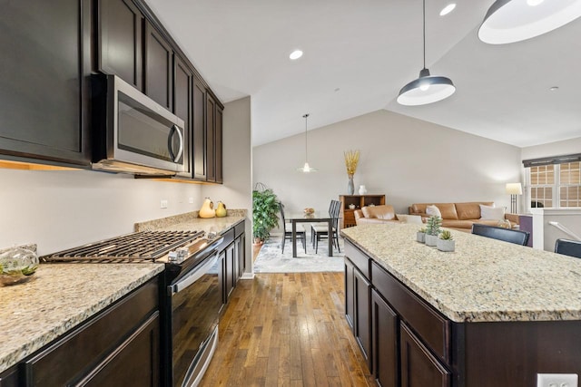 68 Tall Grass Ct, Streamwood, IL 60107 - kitchen with lofted ceiling, stainless steel microwave, hardwood / wood-style floors, open floor plan, and gas stove