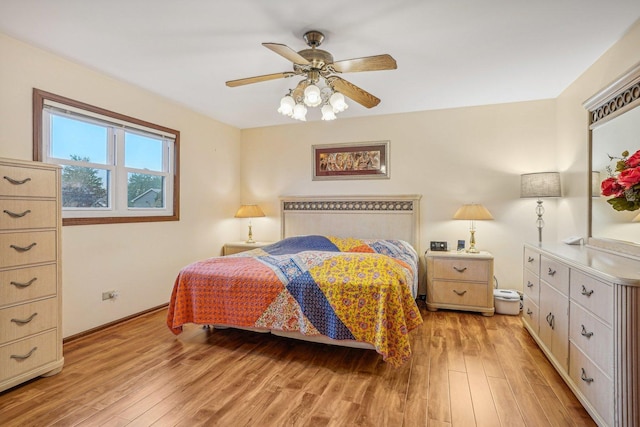 bedroom featuring a ceiling fan, baseboards, and light wood-style floors