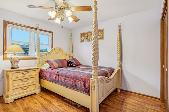 bedroom with light wood-style floors, a ceiling fan, and baseboards