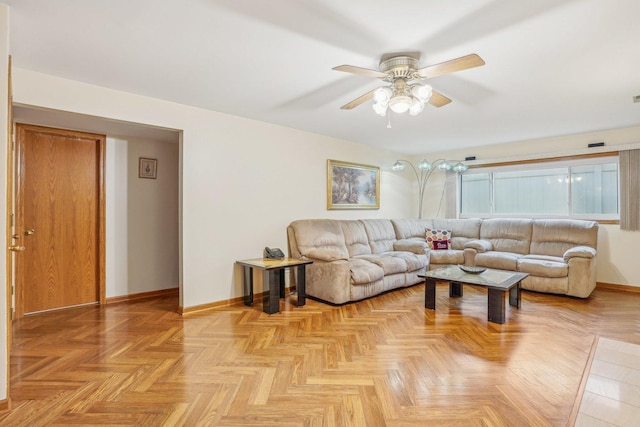 living room with a ceiling fan and baseboards