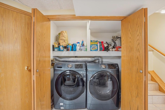 laundry area with tile patterned floors, washer and dryer, and laundry area