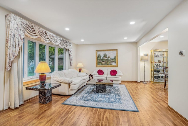 living room with wood finished floors and recessed lighting
