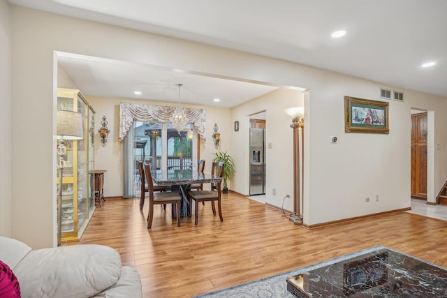 dining area with recessed lighting, visible vents, light wood-type flooring, baseboards, and a notable chandelier