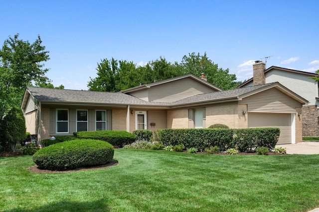 view of front of property featuring brick siding, an attached garage, and a front yard