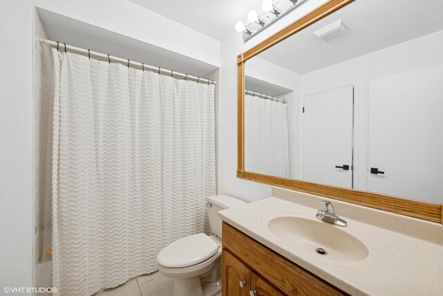 bathroom featuring toilet, visible vents, tile patterned flooring, and vanity