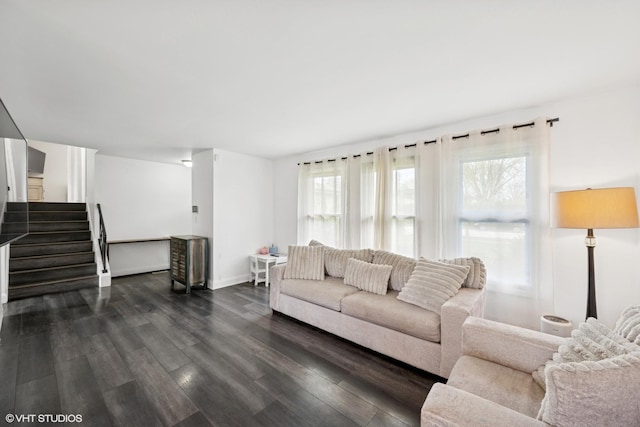 living area with baseboards, stairs, and dark wood finished floors