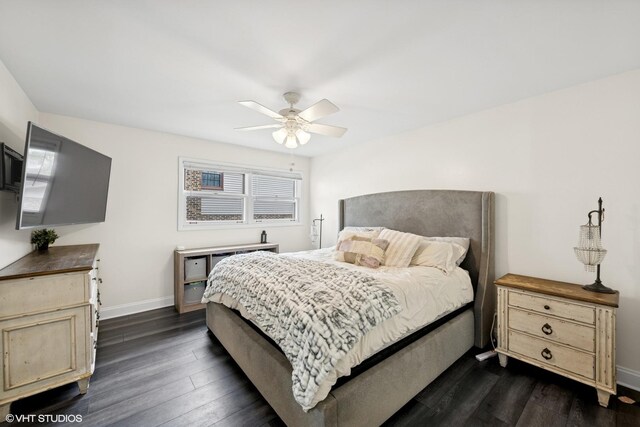 bedroom with baseboards, a ceiling fan, and dark wood-type flooring