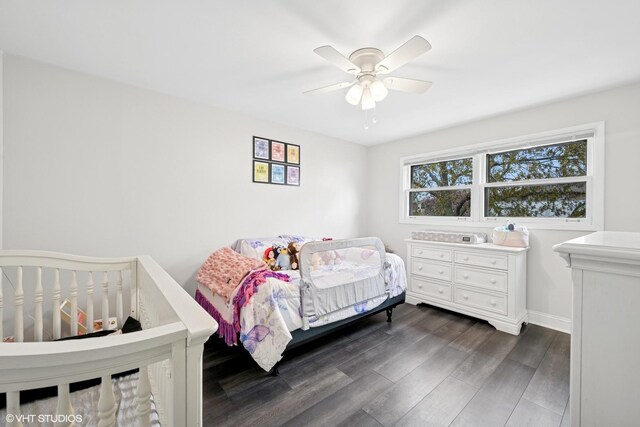 bedroom with a ceiling fan, baseboards, and dark wood-style floors