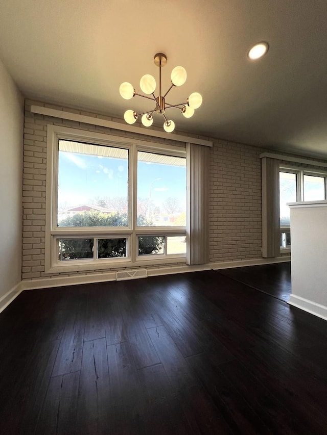 14301 Dorchester Ave, Dolton, IL 60419 - unfurnished dining area with dark wood-type flooring, a notable chandelier, and baseboards