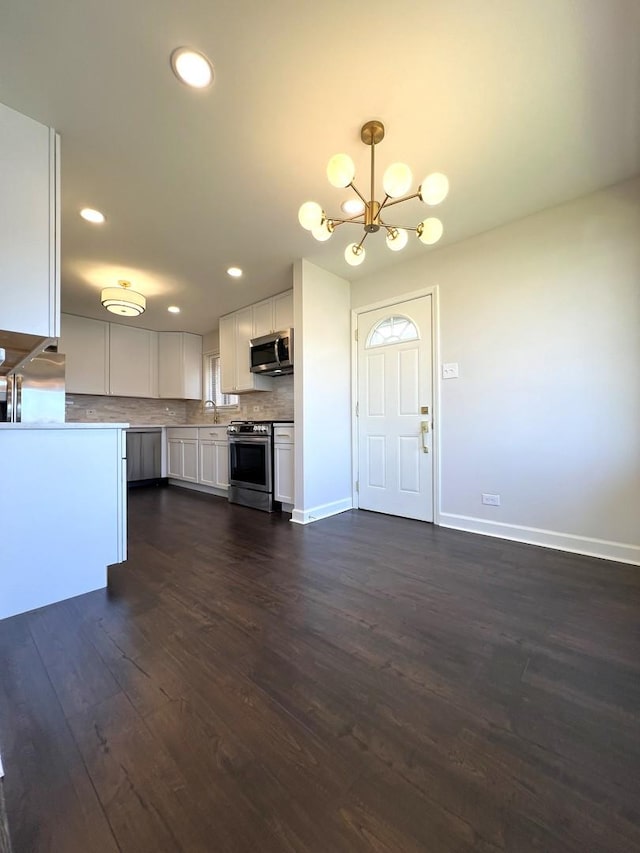 14301 Dorchester Ave, Dolton, IL 60419 - kitchen featuring an inviting chandelier, appliances with stainless steel finishes, white cabinetry, recessed lighting, and backsplash