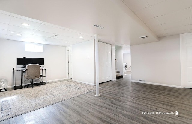 below grade area with wood finished floors, baseboards, washer / clothes dryer, visible vents, and recessed lighting