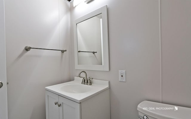 half bath with vanity and toilet