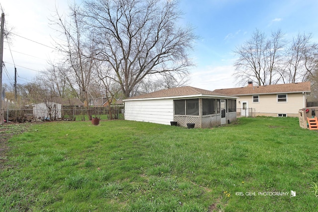 back of property with a lawn, a fenced backyard, and a sunroom