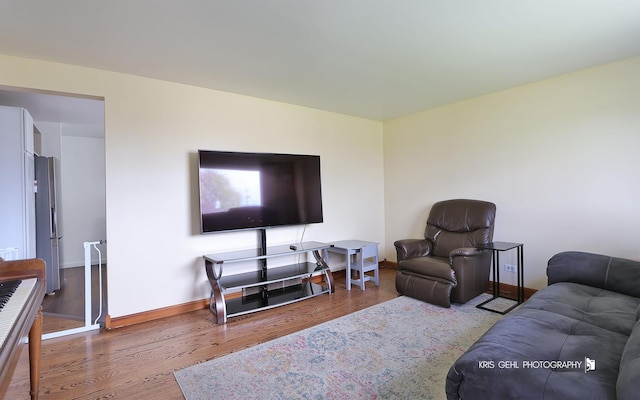 living area with wood finished floors and baseboards