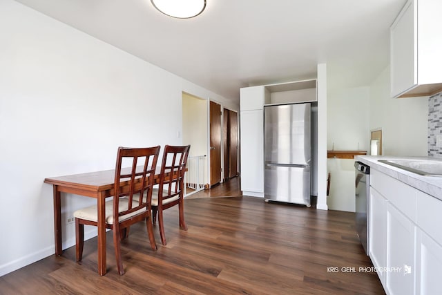 dining space with dark wood finished floors