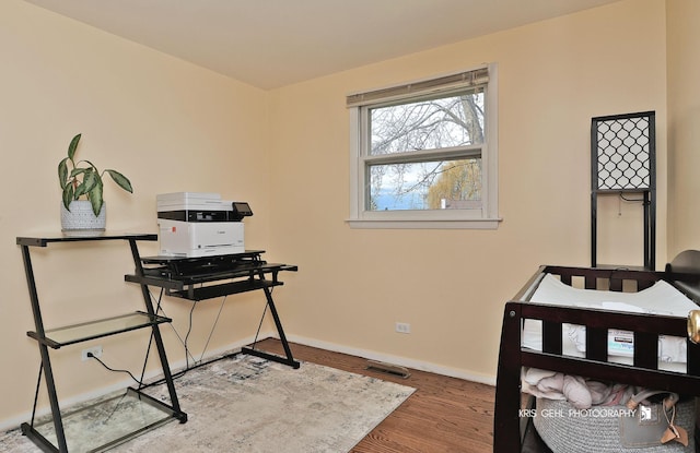 office area with baseboards and wood finished floors