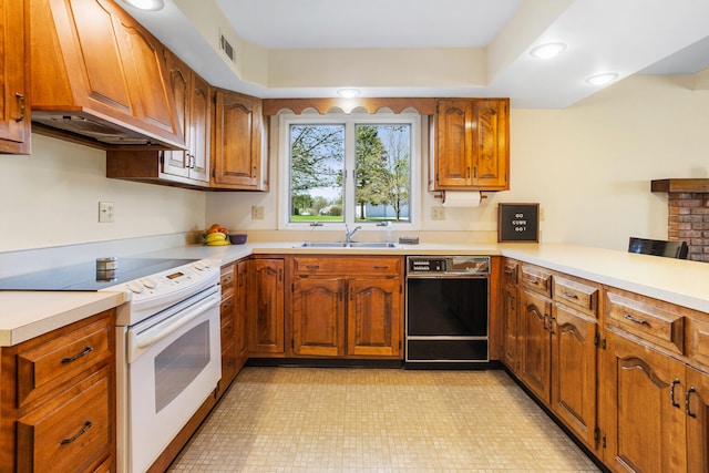 kitchen featuring white range with electric cooktop, brown cabinets, a sink, light countertops, and black dishwasher